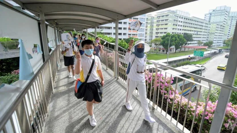 Primary school students arriving at a Singapore school for the new academic term