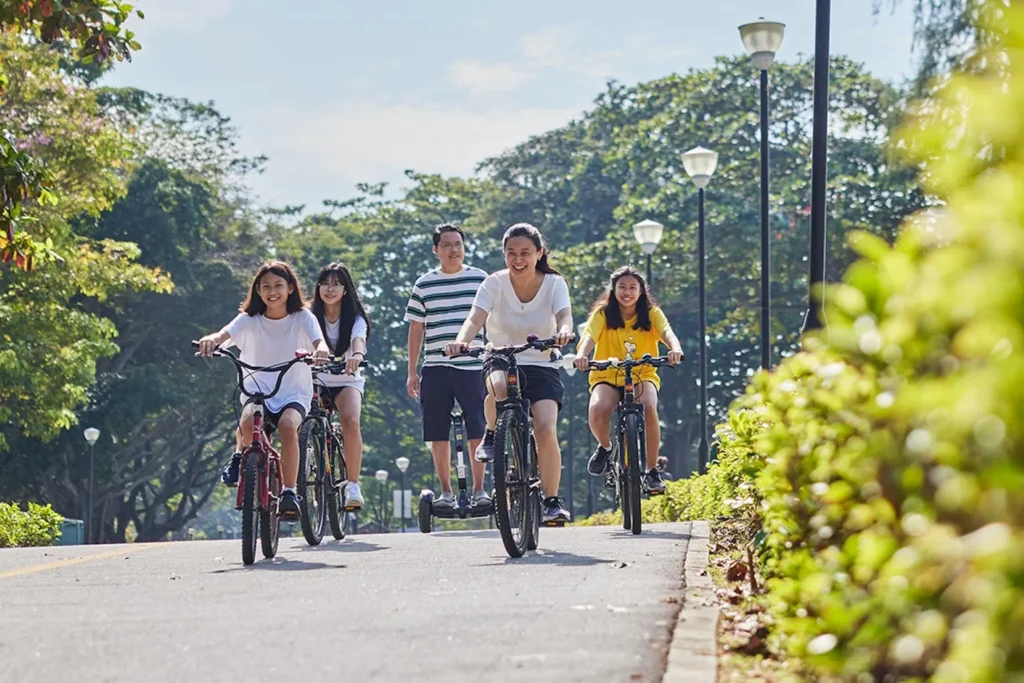 Singapore family enjoying school holidays at East Coast Park beside the coastal walking path